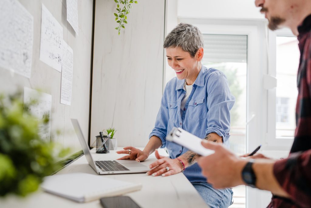 Computer technician helping woman at home with tech issue